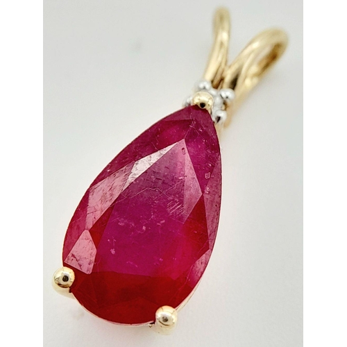 75 - A 10K YELLOW GOLD DIAMOND & PEAR SHAPED RUBY PENDANT. RUBY APPROX 4CT. 2.3G. 2CM. JB7102