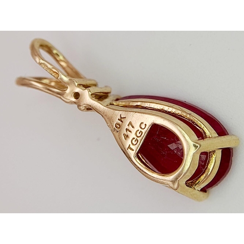 75 - A 10K YELLOW GOLD DIAMOND & PEAR SHAPED RUBY PENDANT. RUBY APPROX 4CT. 2.3G. 2CM. JB7102