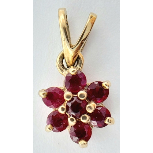 503 - A 9K YELLOW GOLD RUBY SET FLOWER CLUSTER PENDANT 0.6G TOTAL WEIGHT,. Ref: SC 2031