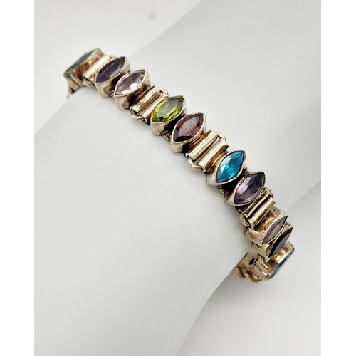 1062 - A Vintage Sterling Silver Topaz, Amethyst, Peridot and Garnet T-Bar Bracelet. 19cm Length. The Brace... 