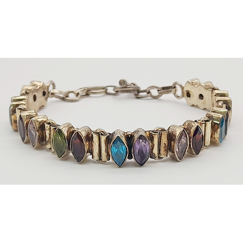 1062 - A Vintage Sterling Silver Topaz, Amethyst, Peridot and Garnet T-Bar Bracelet. 19cm Length. The Brace... 