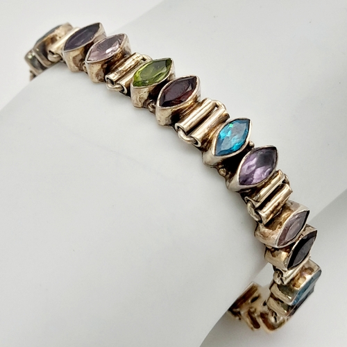 1062 - A Vintage Sterling Silver Topaz, Amethyst, Peridot and Garnet T-Bar Bracelet. 19cm Length. The Brace... 