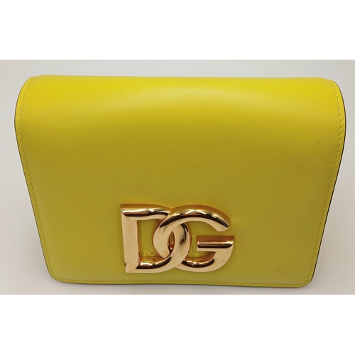 391 - A Dolce & Gabbana Crossbody Bag. Smooth yellow leather exterior with gold-toned hardware, featuring ... 