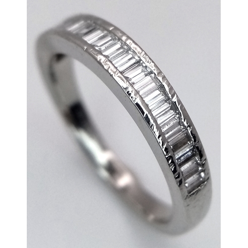 61 - A PLATINUM AND DIAMOND HALF ETERNITY RING. BAGUETTE CUT DIAMONDS - 0.65CTW. 4.3G. SIZE L. JRS1001.