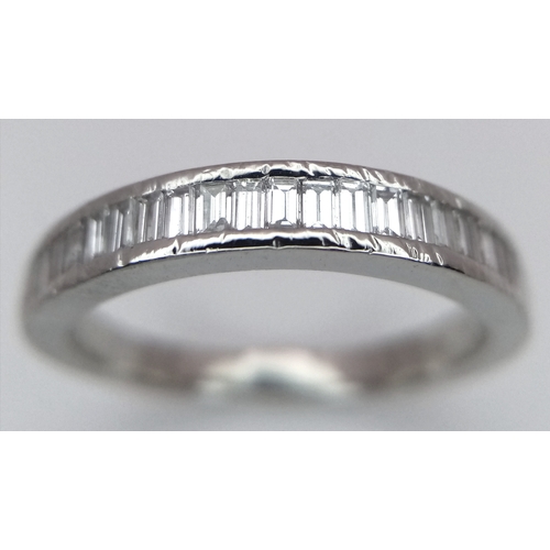 61 - A PLATINUM AND DIAMOND HALF ETERNITY RING. BAGUETTE CUT DIAMONDS - 0.65CTW. 4.3G. SIZE L. JRS1001.