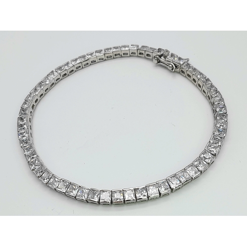 1048 - A Sterling Silver Clear Stone Set Tennis Bracelet- 19.5cm Length. The bracelet measures 4mm Wide and... 