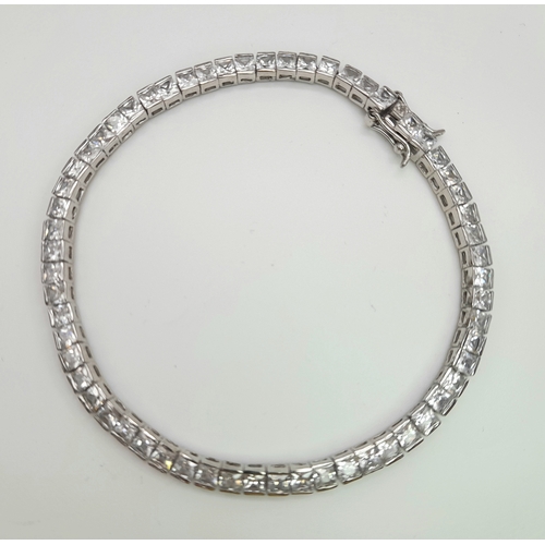 1048 - A Sterling Silver Clear Stone Set Tennis Bracelet- 19.5cm Length. The bracelet measures 4mm Wide and... 