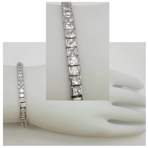 1048 - A Sterling Silver Clear Stone Set Tennis Bracelet- 19.5cm Length. The bracelet measures 4mm Wide and... 