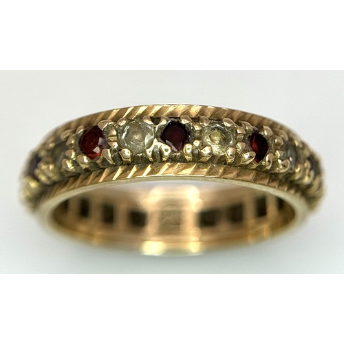 245 - Beautiful 9 CARAT GOLD ETERNITY RING. Set with Garnet and Aqua gemstones. 3 grams. Size L 1/2.