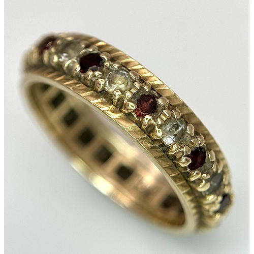 245 - Beautiful 9 CARAT GOLD ETERNITY RING. Set with Garnet and Aqua gemstones. 3 grams. Size L 1/2.