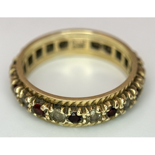 245 - Beautiful 9 CARAT GOLD ETERNITY RING. Set with Garnet and Aqua gemstones. 3 grams. Size L 1/2.