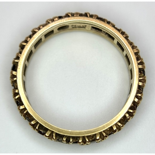 245 - Beautiful 9 CARAT GOLD ETERNITY RING. Set with Garnet and Aqua gemstones. 3 grams. Size L 1/2.