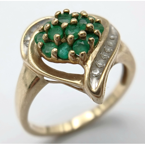 557 - A Quality 9 Carat Yellow Gold Emerald and Diamond Heart Design Ring Size N. The ring is set with 13 ... 