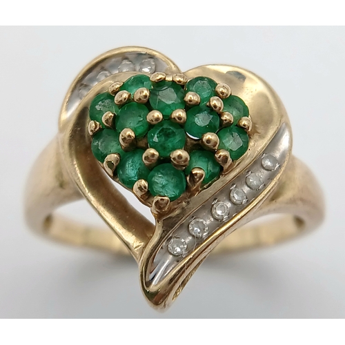 557 - A Quality 9 Carat Yellow Gold Emerald and Diamond Heart Design Ring Size N. The ring is set with 13 ... 