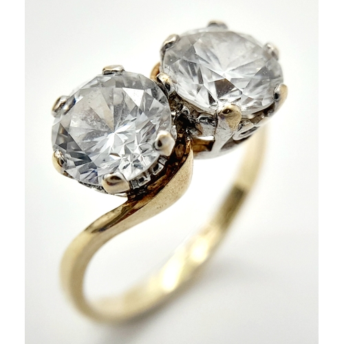 56 - Fabulous 9 CARAT GOLD RING. Crossover style with 2 x large beautifully cut SEARCHLIGHT ZIRCONIAS. 2.... 