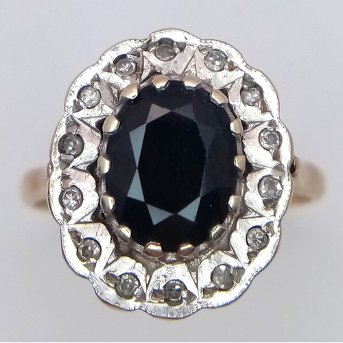 665 - An Impressive SPINEL and DIAMOND RING. Consisting A large Oval Cut Centre Spinel with  Diamond Surro... 