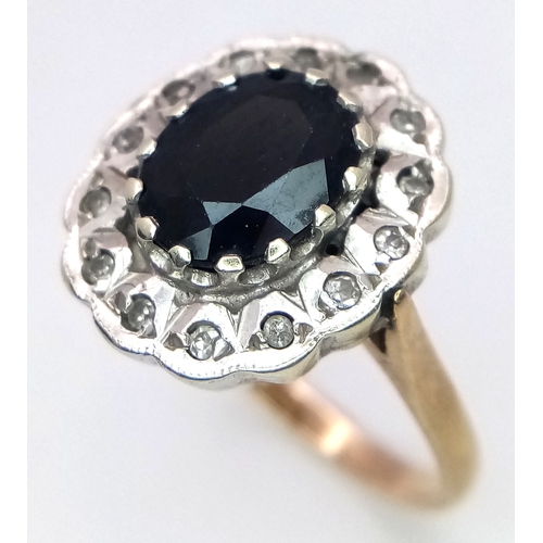 665 - An Impressive SPINEL and DIAMOND RING. Consisting A large Oval Cut Centre Spinel with  Diamond Surro... 