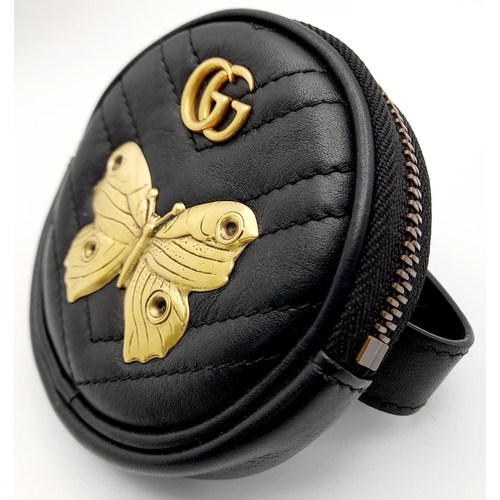 717 - A Gucci Butterfly Carry Pouch. Circular form with butterfly and monogram decoration. Velcro strap. 9... 