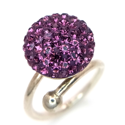 1210 - A Sterling Silver Purple Crystal Set Ring Size M. The Crown Measures 1.5cm Diameter. Gross Weight 4.... 