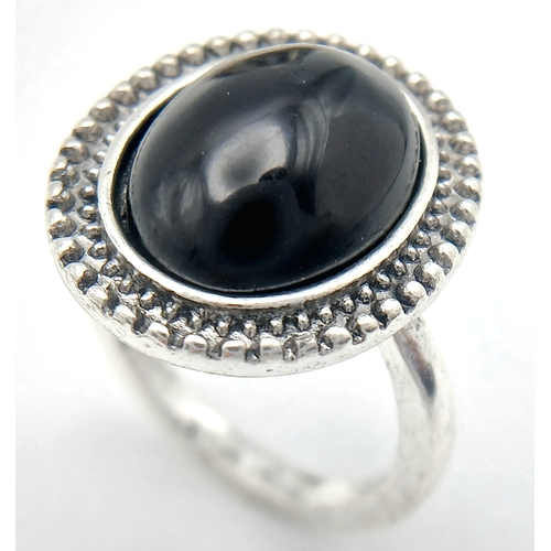 1663 - A Black Agate suite comprising a cuff, a pendant on chain, and a ring. Approx. measurements: ring si... 