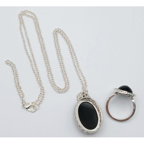 1663 - A Black Agate suite comprising a cuff, a pendant on chain, and a ring. Approx. measurements: ring si... 