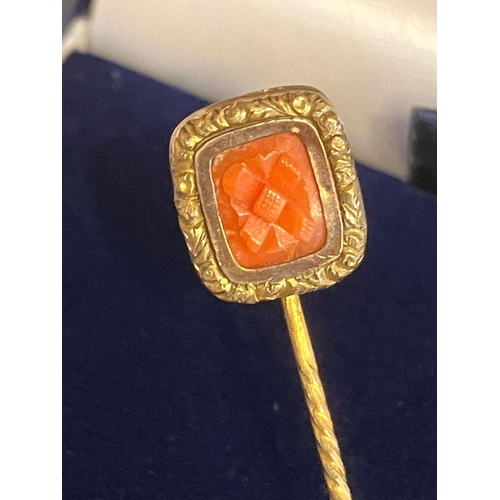 385 - Antique Yellow Metal Stick Pin with GOLD FINIAL set with Carnelian. 1.29 grams.