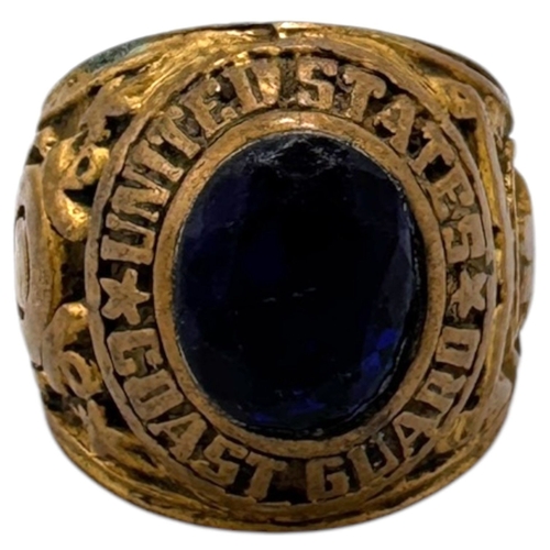 1330 - A Vietnam war era US Coast Guard fraternity Ring, featuring a central dark blue oval stone and a sta... 