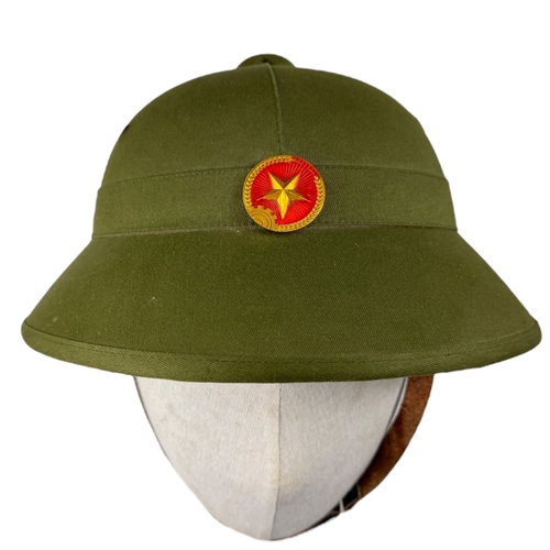 1337 - A Vietnam war era Vietcong Helmet with original strap and badge.
Some minor wear but no visible stai... 