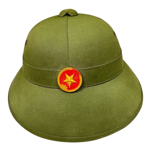 1337 - A Vietnam war era Vietcong Helmet with original strap and badge.
Some minor wear but no visible stai... 