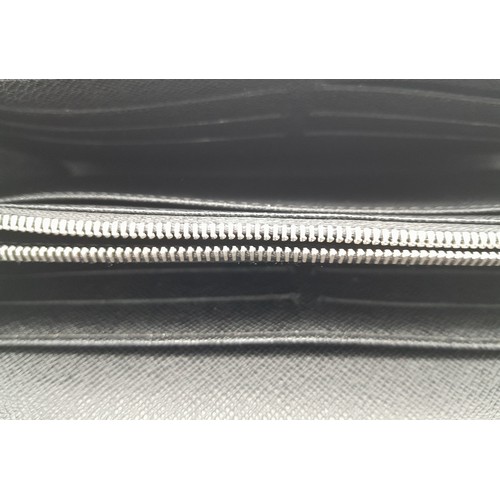 615 - A Louis Vuitton Epi Sarah Wallet. Dark blue Epi leather exterior with silver-toned hardware. Envelop... 