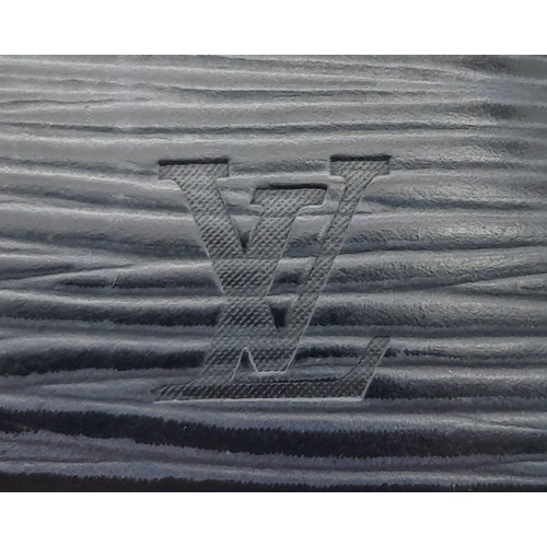 615 - A Louis Vuitton Epi Sarah Wallet. Dark blue Epi leather exterior with silver-toned hardware. Envelop... 