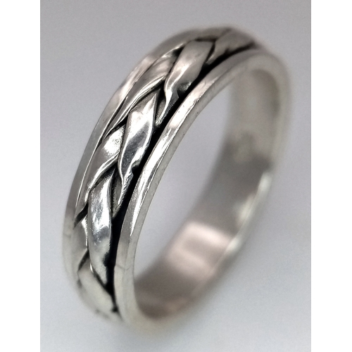 1203 - A Sterling Silver Celtic Design Spinner Band Ring Size Q. The Ring has a band width of 6mm and weigh... 