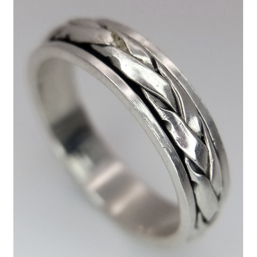 1203 - A Sterling Silver Celtic Design Spinner Band Ring Size Q. The Ring has a band width of 6mm and weigh... 