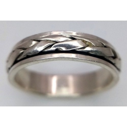 1203 - A Sterling Silver Celtic Design Spinner Band Ring Size Q. The Ring has a band width of 6mm and weigh... 