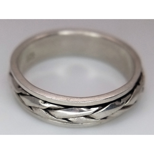 1203 - A Sterling Silver Celtic Design Spinner Band Ring Size Q. The Ring has a band width of 6mm and weigh... 