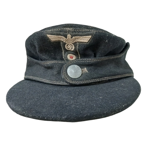 1206 - A WW2 German M43 Panzer Cap. Dated 1944. Size 58.