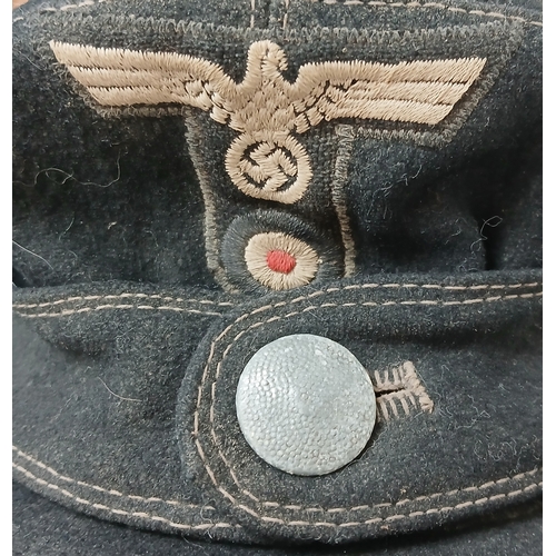 1206 - A WW2 German M43 Panzer Cap. Dated 1944. Size 58.