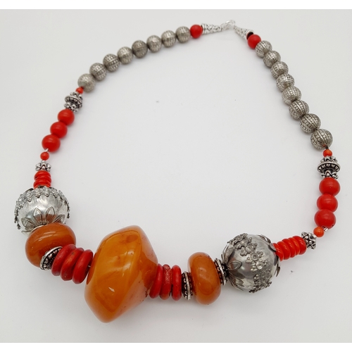 1565 - A graduated resin and coral Berber suite featuring a necklace with silver-toned metal beads, coral a... 