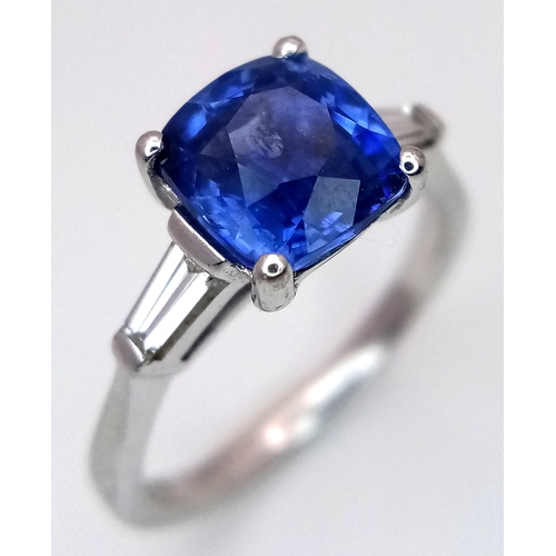 522 - A WGI Certified 18K White Gold, Sapphire and Diamond Ring. A 2ct cushion cut central sapphire with 0... 