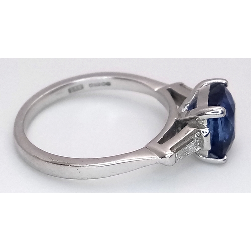 522 - A WGI Certified 18K White Gold, Sapphire and Diamond Ring. A 2ct cushion cut central sapphire with 0... 