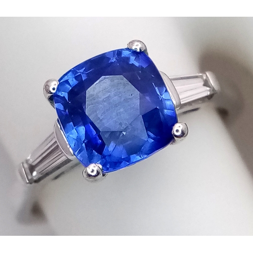 522 - A WGI Certified 18K White Gold, Sapphire and Diamond Ring. A 2ct cushion cut central sapphire with 0... 