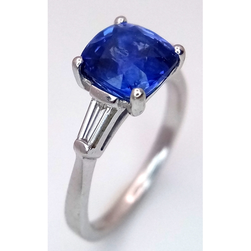 522 - A WGI Certified 18K White Gold, Sapphire and Diamond Ring. A 2ct cushion cut central sapphire with 0... 