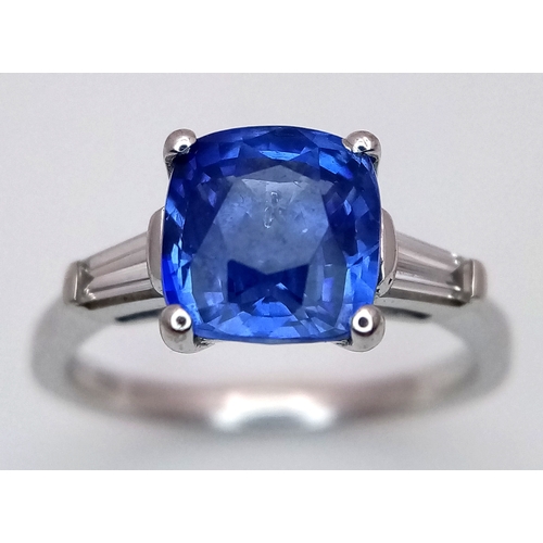 522 - A WGI Certified 18K White Gold, Sapphire and Diamond Ring. A 2ct cushion cut central sapphire with 0... 