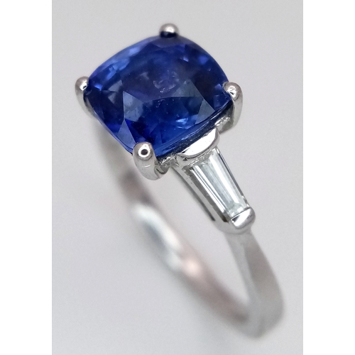 522 - A WGI Certified 18K White Gold, Sapphire and Diamond Ring. A 2ct cushion cut central sapphire with 0... 