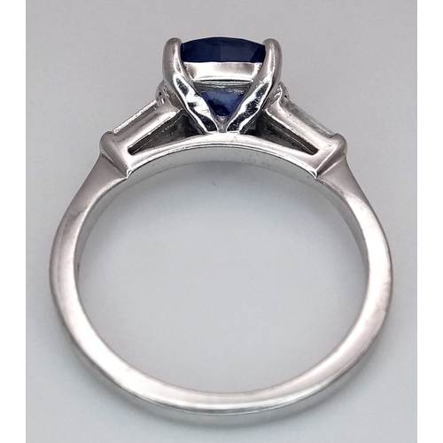 522 - A WGI Certified 18K White Gold, Sapphire and Diamond Ring. A 2ct cushion cut central sapphire with 0... 