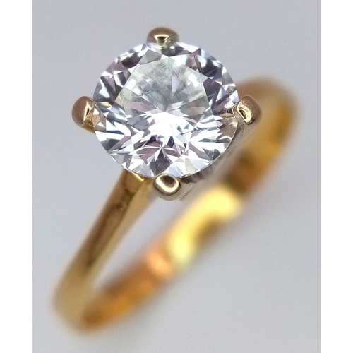 65 - A WGI Certified 18K Yellow Gold and Diamond Solitaire Ring. A 1.02ct brilliant round cut diamond. SI... 