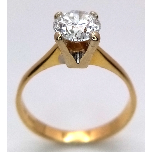 65 - A WGI Certified 18K Yellow Gold and Diamond Solitaire Ring. A 1.02ct brilliant round cut diamond. SI... 