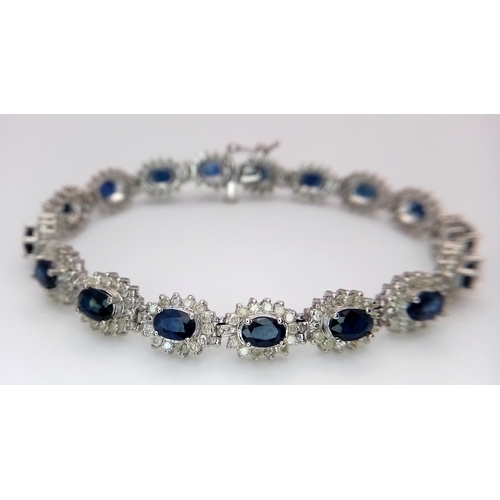 663 - A Beautiful 14K White Gold, Sapphire and Diamond Bracelet. Seventeen oval cut sapphires each with a ... 