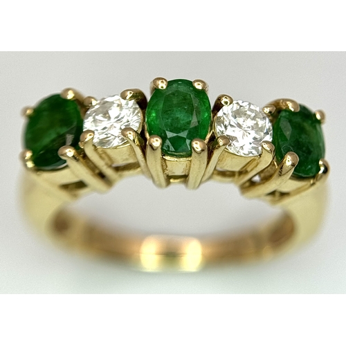 121 - A Mesmerising 14K Yellow Gold Emerald and Diamond Ring. 0.75ctw of oval cut emeralds alternate with ... 