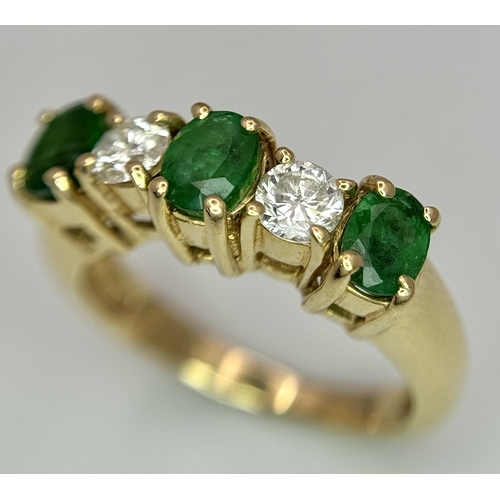 121 - A Mesmerising 14K Yellow Gold Emerald and Diamond Ring. 0.75ctw of oval cut emeralds alternate with ... 